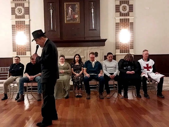 A seated group of volunteers at a Chicago area holiday corporate hypnosis show.