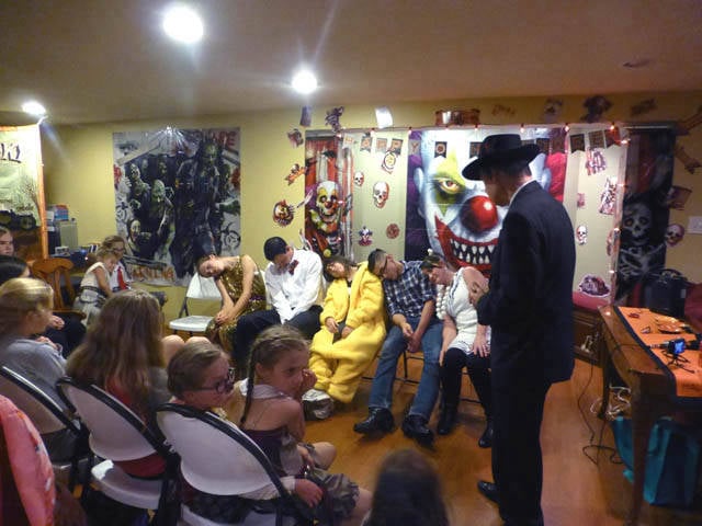 A group of costumed volunteers at a Chicago area Halloween home hypnosis show.
