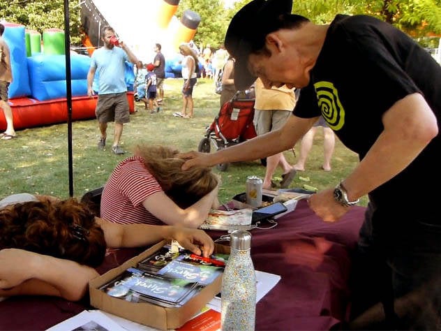 Two girls being hypnotized at a Chicago park festival.