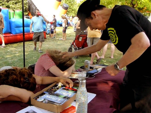 Two girls being hypnotized at a Chicago park festival.