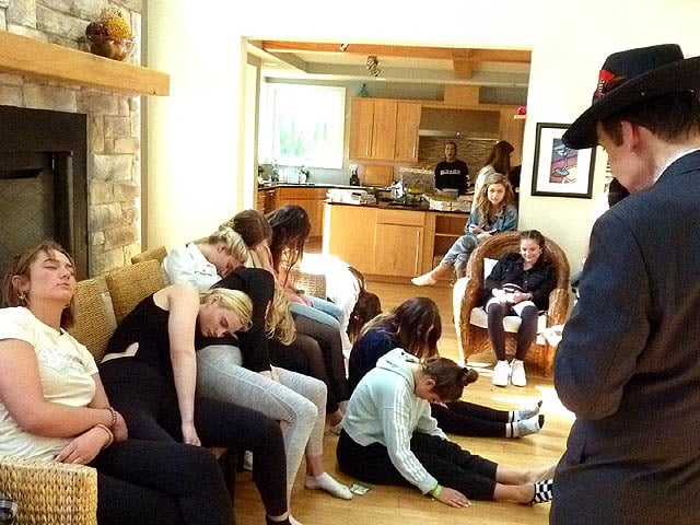 Volunteers slumped over on each other at a Chicago area sorority hypnosis show.
